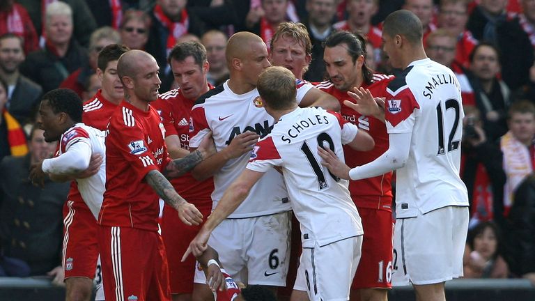 Paul Scholes of Manchester United clashes with Jamie Carragher of Liverpool as Nani lies injured during the Barclays Premier League match between Liverpool and Manchester United at Anfield on March 6, 2011 in Liverpool, England. 