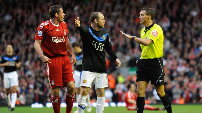 Wayne Rooney protests to Referee Andre Marriner after Michael Owen of Manchester United is brought down by Jamie Carragher of Liverpool during the Barclays Premier League match between Liverpool and Manchester United at Anfield on October 25, 2009 in Liverpool, England. 