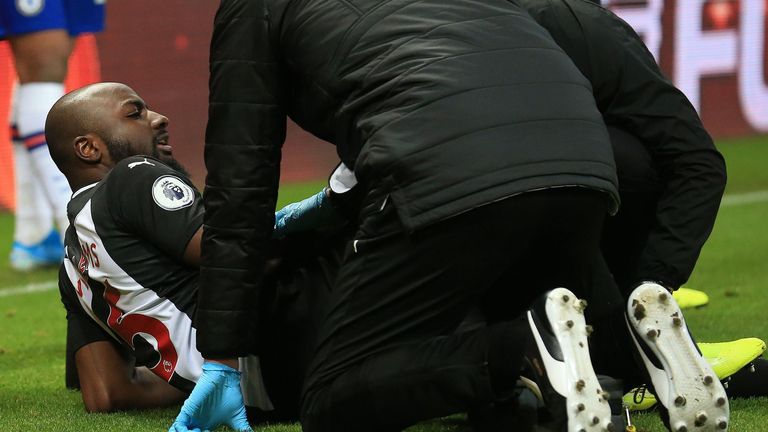 Newcastle United's Dutch defender Jetro Willems receives medical treatment before being stretchered off injured during the English Premier League football match between Newcastle United and Chelsea at St James' Park in Newcastle-upon-Tyne, north east England on January 18, 2020. 
