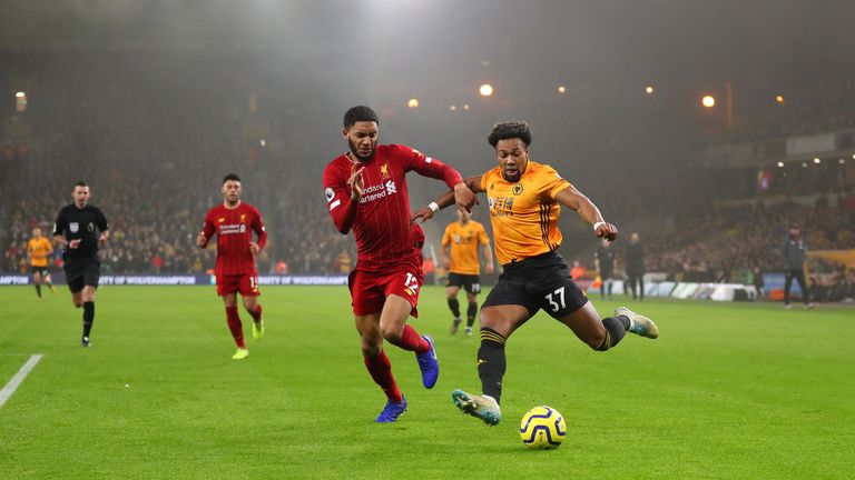 Wolves' Adama Traore runs at Liverpool defender Joe Gomez