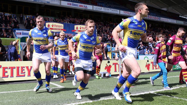 PICTURE BY VAUGHN RIDLEY/SWPIX.COM - Rugby League - Tetley's Challenge Cup, 5th Round - Huddersfield Giants v Leeds Rhinos - John Smiths Stadium, Huddersfield, England - 11/05/13 - Leeds Kevin Sinfield and Huddersfield's Danny Brough lead their teams out onto the pitch. Jamie Peacock and Rob Burrow.