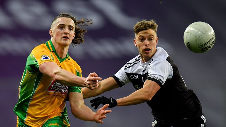 Kieran Molloy of Corofin in action against Jerome Johnston of Kilcoo