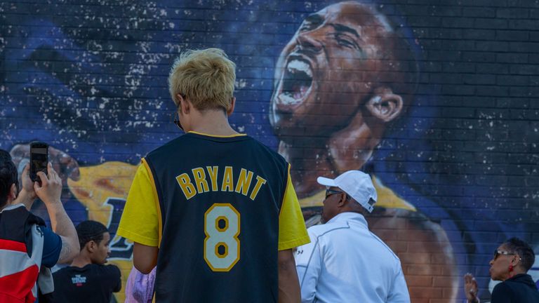 Lakers fans pictured in front of a mural honouring the late Kobe Bryant