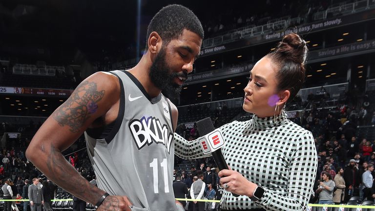 Kyrie Irving is consoled by NBA sideline reporter Cassidy Hubbarth after Brooklyn&#39;s win over Detroit
