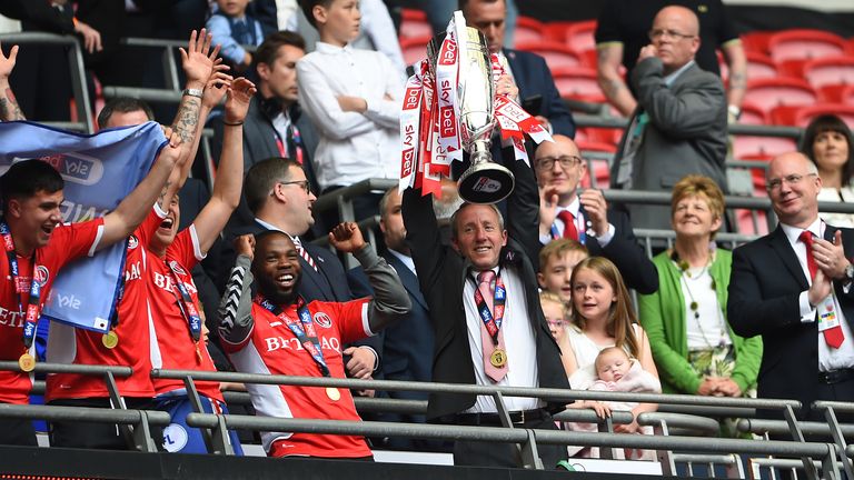 Lee Bowyer celebrates with the Sky Bet League One play-off final trophy 