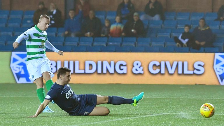 Leigh Griffiths flashes his shot beyond Jan Koprivec  to double Celtic's lead