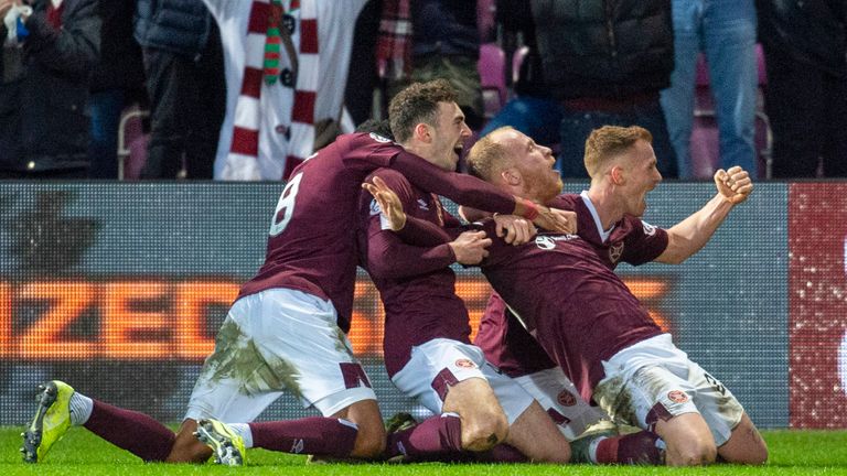 Boyce is mobbed after marking his Hearts debut with a late winner