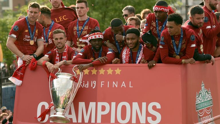 Liverpool players with the Champions League trophy on their open-top bus parade
