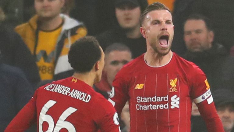 Jordan Henderson celebrates scoring Liverpool's first goal against Wolves with team-mate Trent Alexander-Arnold