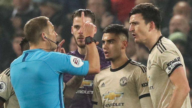 Manchester United's players react towards referee Craig Pawson after the second goal was disallowed during the Premier League game at Anfield