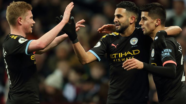 Riyad Mahrez is congratulated by Kevin De Bruyne and Joao Cancelo after his second goal at Aston Villa