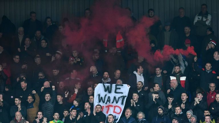 Manchester United fans protest against the owners at their fourth-round FA Cup game against Tranmere