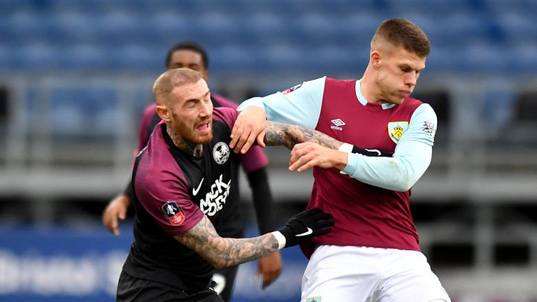 Peterborough United's Marcus Maddison (left) and Burnley's Johann Berg Gudmundsson battle for the ball during the FA Cup third round match at Turf Moor