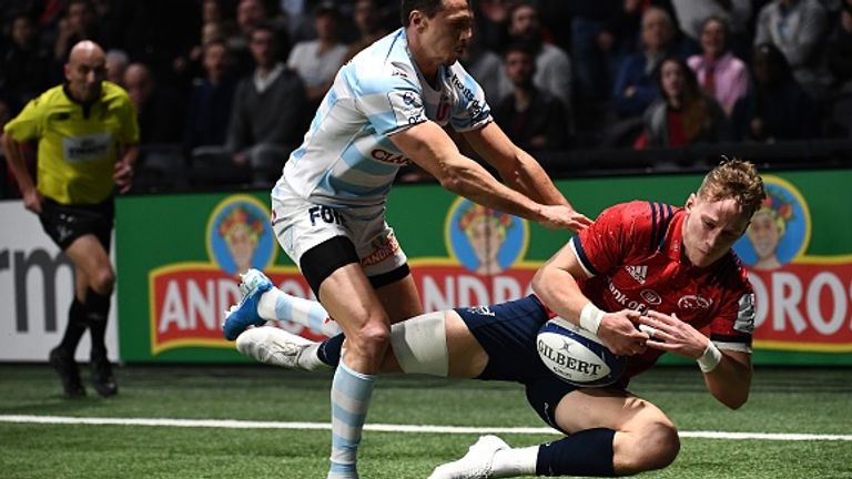 Racing 92's Juan Imhoff tries to tackle Munster's Mike Haley during their fiercely contested pool match