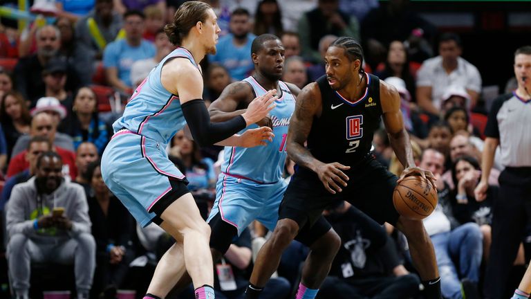 Kawhi Leonard #2 of the LA Clippers is defended by Dion Waiters #11 and Kelly Olynyk #9 of the Miami Heat during the second half at American Airlines Arena on January 24, 2020 in Miami, Florida