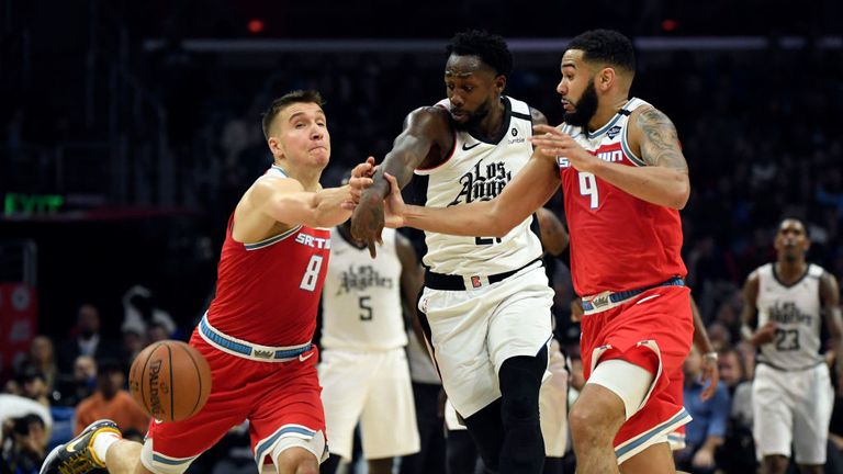 Patrick Beverley #21 of the Los Angeles Clippers steals the ball from Cory Joseph #9 and Bogdan Bogdanovic #8 of the Sacramento Kings during the second half at Staples Center on January 30, 2020 in Los Angeles, California. 