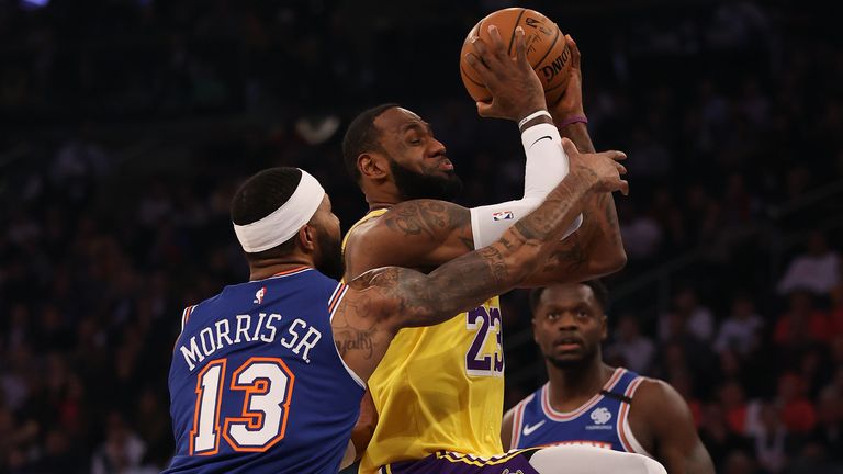 LeBron James #23 of the Los Angeles Lakers is fouled by Marcus Morris Sr. #13 of the New York Knicks in the first quarter at Madison Square Garden on January 22, 2020 in New York City. 