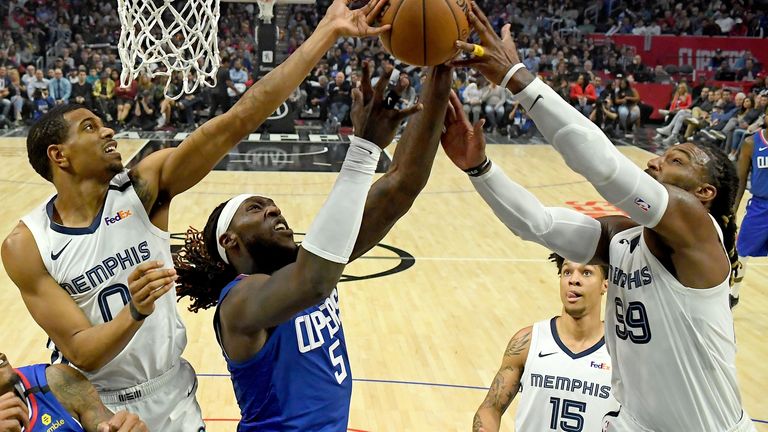 Montrezl Harrell's charge to the rim is halted by two Grizzlies defenders on a difficult night for the Clippers