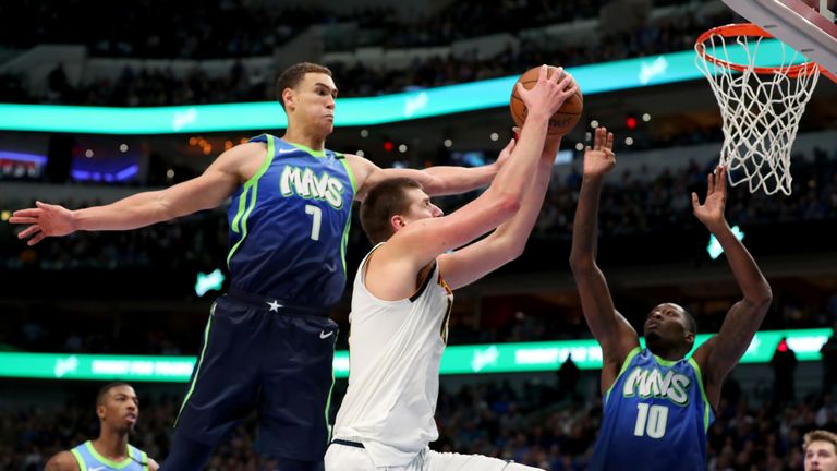 Nikola Jokic #15 of the Denver Nuggets drives to the basket against Dwight Powell #7 of the Dallas Mavericks in the second half at American Airlines Center on January 08, 2020 in Dallas, Texas. 