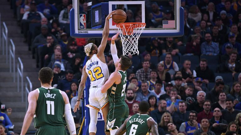 Ky Bowman #12 of the Golden State Warriors slam dunks over Kyle Korver #26 of the Milwaukee Bucks during the first half of an NBA basketball game at Chase Center on January 08, 2020 in San Francisco, California. 