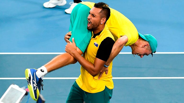 Nick Kyrgios of Australia carries teammate Alex de Minaur after winning their men's doubles match against Jamie Murray and Joe Salisbury of Britain at the ATP Cup tennis tournament in Sydney on January 9, 2020.
