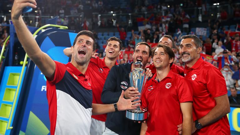 Novak Djokovic of Serbia poses for a selfie with team mates after winning the ATP Cup final against Spain during day 10 of the ATP Cup at Ken Rosewall Arena on January 12, 2020 in Sydney, Australia. 
