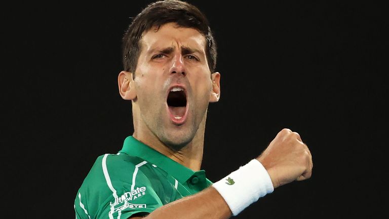 Serbia's Novak Djokovic reacts after winning his first set against Canada's Milos Raonic during their men's singles quarter-final match on day nine of the Australian Open tennis tournament in Melbourne on January 28, 2020