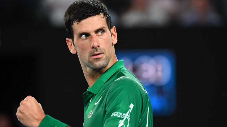 Serbia's Novak Djokovic reacts as he plays against Switzerland's Roger Federer during their men's singles semi-final match on day eleven of the Australian Open tennis tournament in Melbourne on January 30, 2020