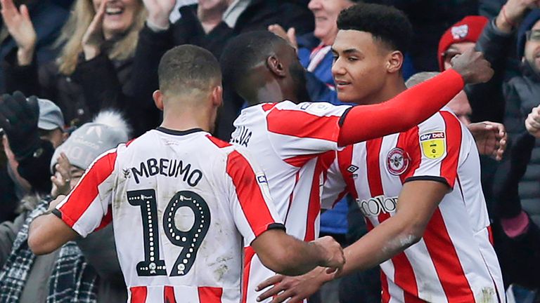 Ollie Watkins of Brentford celebrates with team-mates after scoring their third goal