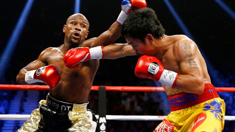 Floyd Mayweather Jr. throws a right at Manny Pacquiao during their welterweight unification championship bout on May 2, 2015 at MGM Grand Garden Arena in Las Vegas, Nevada. 