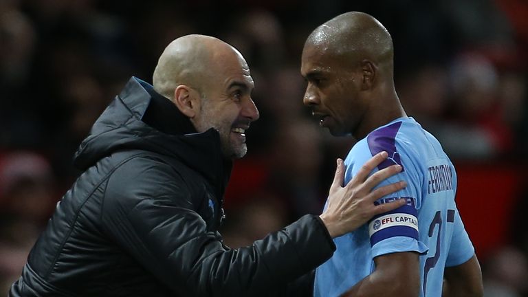 Pep Guardiola and Fernandinho during Manchester City's cup win over Manchester United at Old Trafford