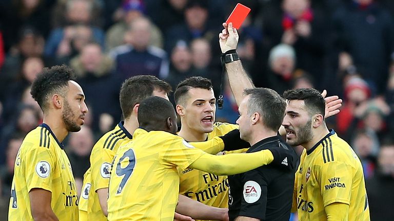 Referee Paul Tierney shows a red card to Pierre-Emerick Aubameyang