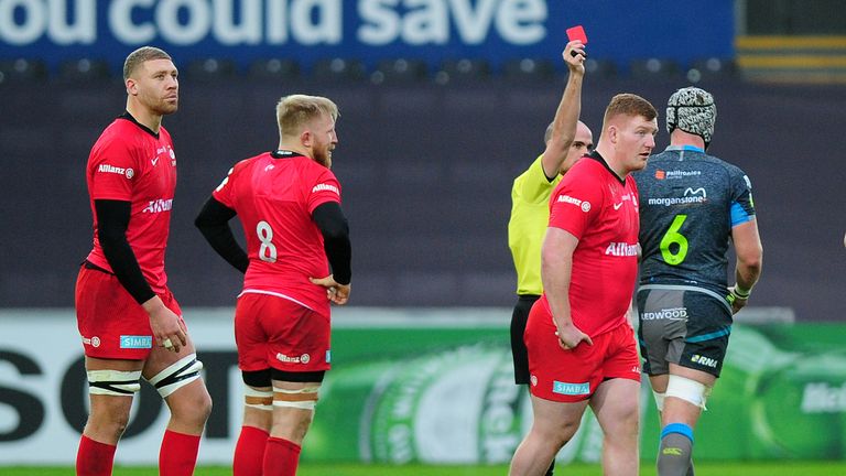 Rhys Carre of Saracens is shown a red card 