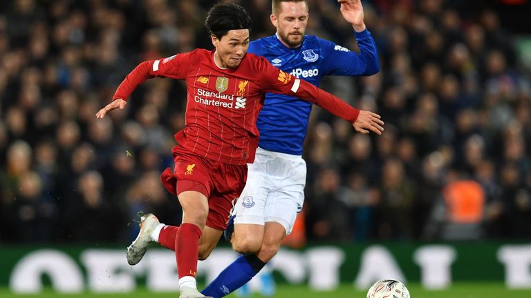 Takumi Minamino of Liverpool takes on Gylfi Sigurdsson of Everton in the FA Cup third-round tie at Anfield in January 2020