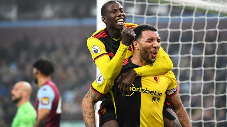Troy Deeney celebrates his goal against Villa with Abdoulaye Doucoure