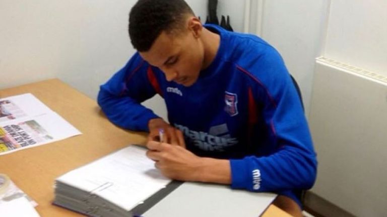 Tyrone Mings signing his first contract with Ipswich