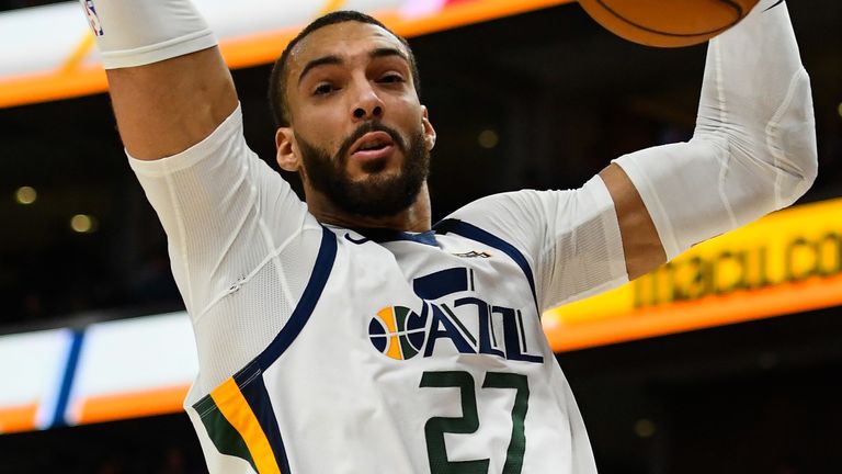 Rudy Gobert locks eyes with camera after dropping a dunk against the Dallas Mavericks