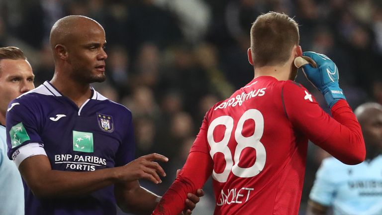 Vincent Kompany consoles Simon Mignolet after Anderlecht fans threw a flare at the Club Brugge goalkeeper