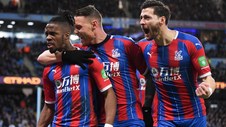 Wilfried Zaha, Connor Wickham and Joel Ward celebrate after Crystal Palace secure a point at the Etihad Stadium