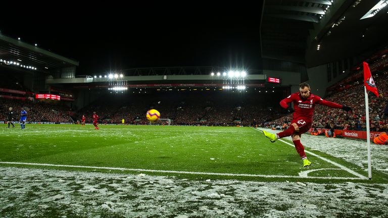 Xherdan Shaqiri takes a corner in the snow during Liverpool vs Leicester