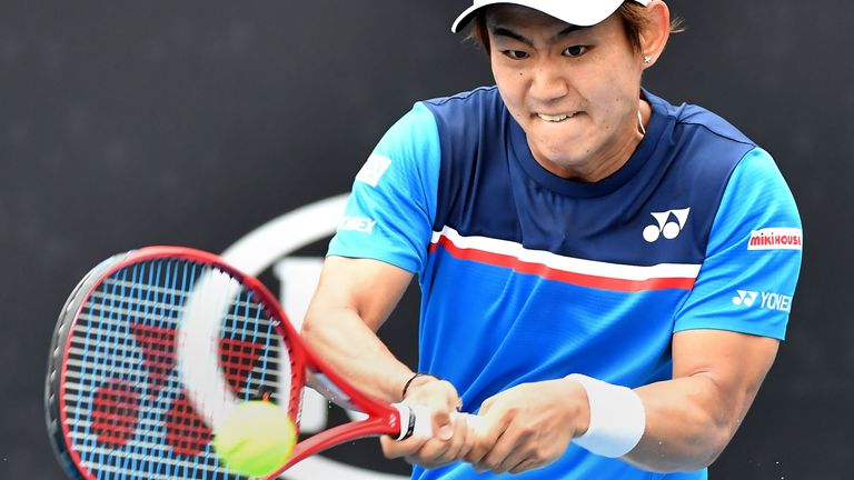 Japan's Yoshihito Nishioka hits a return against Serbia's Laslo Djere during their men's singles match on day one of the Australian Open tennis tournament in Melbourne on January 20, 2020. 