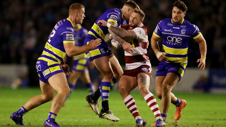 Picture by Paul Currie/SWpix.com - 15/03/2019 - Rugby League - Betfred Super League - Warrington Wolves v Wigan Warriors - Halliwell Jones Stadium, Warrington, England - Zak Hardacre of Wigan Warriors is tackled by the Warrington defence