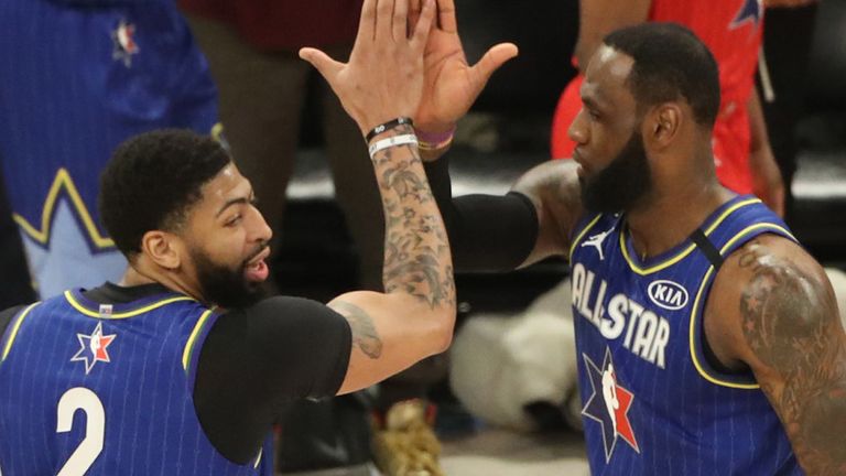 Anthony Davis high-fives team captain LeBron James during the All-Star Game