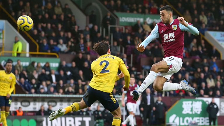 Dwight McNeil gets to the ball before Hector Bellerin during the contest at Turf Moor