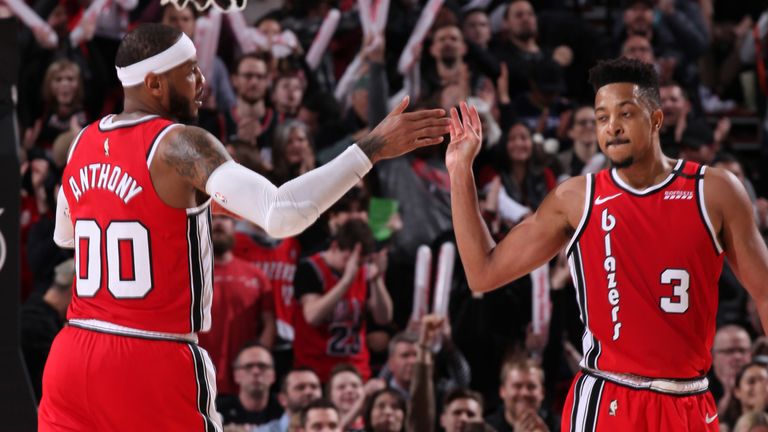 Carmelo Anthony and CJ McCollum share a high-five