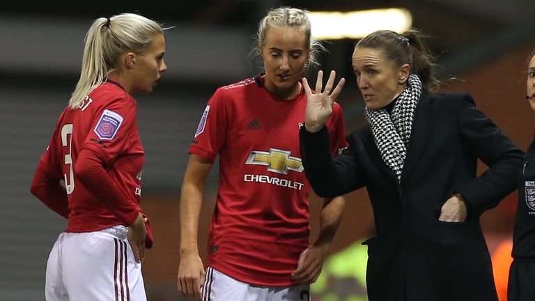 Manchester United Women manager Casey Stoney speaks to Lottie Okvist and Millie Turner earlier in the season