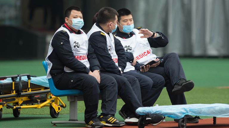 SHANGHAI, CHINA - JANUARY 28: Members of medical team wear masks during the AFC Champions League Preliminary Round match between Shanghai SIPG and Buriram United at Yuanshen Sports Centre Stadium on January 28, 2020 in Shanghai, China. Shanghai SIPG is playing Buriram United before an empty stadium due to the spread of the new coronavirus. (Photo by Yifan Ding/Getty Images)