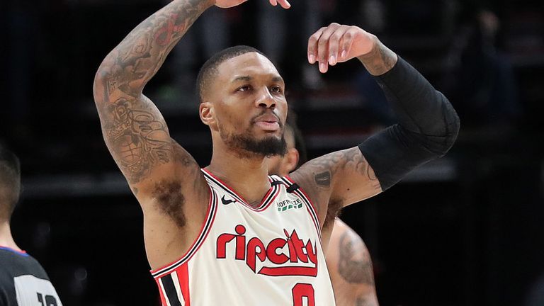 Damian Lillard encourages the Portland fans after hitting a shot against Miami 