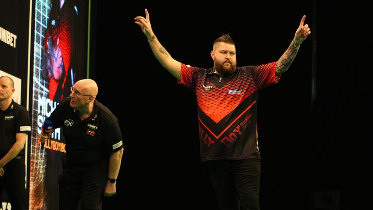 Michael Smith celebrates after hitting a nine-darts in Dublin