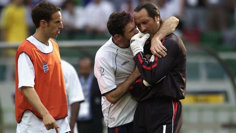 David Seaman is consoled after his mistake in the World Cup quarter-final against Brazil in 2002